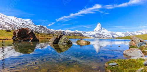 Beautiful panoramic summer view of the Stellisee lake with reflection of the iconic Matterhorn (Monte Cervino, Mont Cervin) and clear blue sky on water, Swiss Alps, Zermatt, Switzerland, Europe