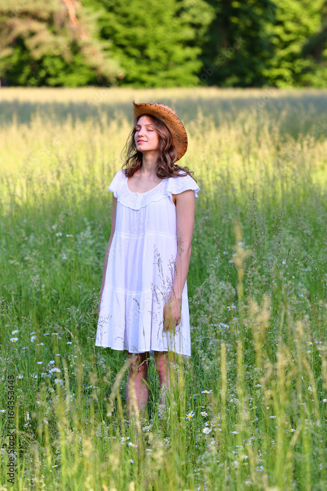 Relaxing woman standing in green field, outdoor, nature, grass Relaxing woman standing in green field, outdoor, nature, grass