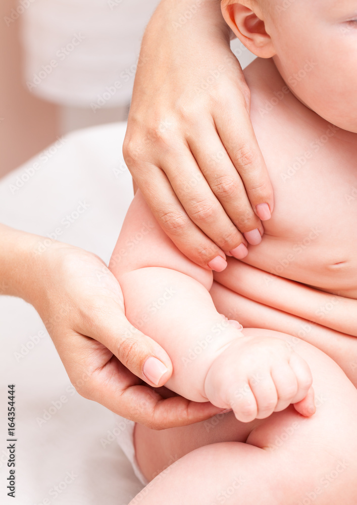 Little baby receiving osteopathic treatment of her arm Little baby receiving osteopathic treatment of her arm