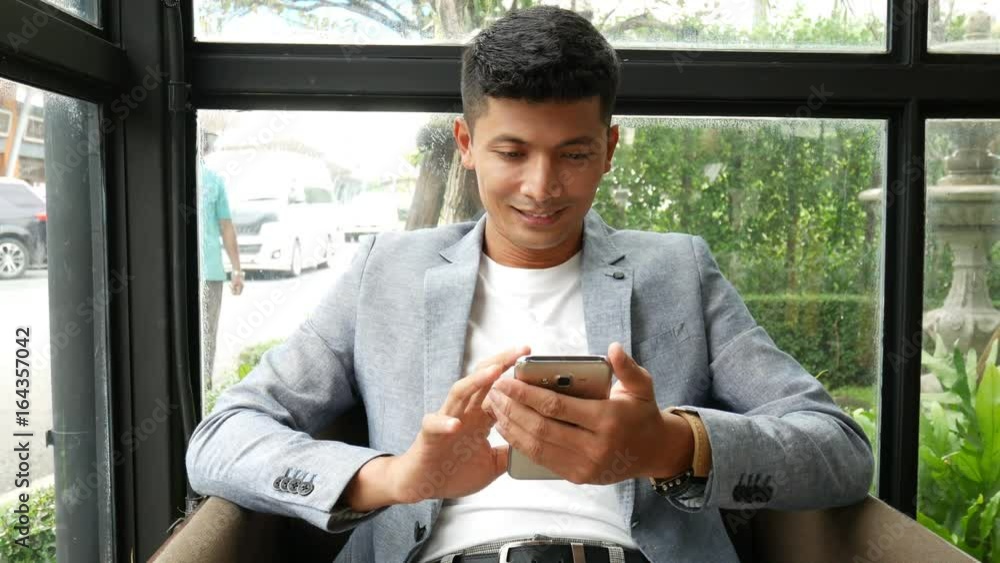 Business man using smart phone in the coffee shop Business man using smart phone in the coffee shop