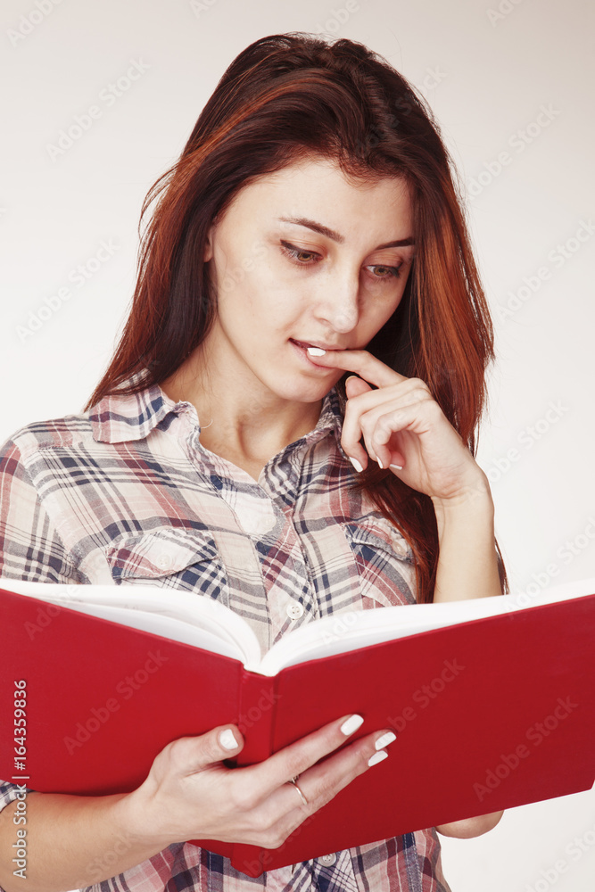 Heavy and boring learning. Young girl with books. (Science, effort, facial expression, body language, gestures of the concept) Heavy and boring learning. Young girl with books. (Science, effort, facial expression, body language, gestures of the concept)