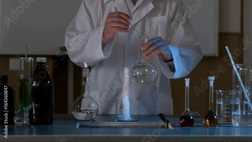 Scientist in a laboratory conducting an experiment on the instantaneous transformation of the liquid into ice. The chemical effect of the liquid or water will instantly freeze photo