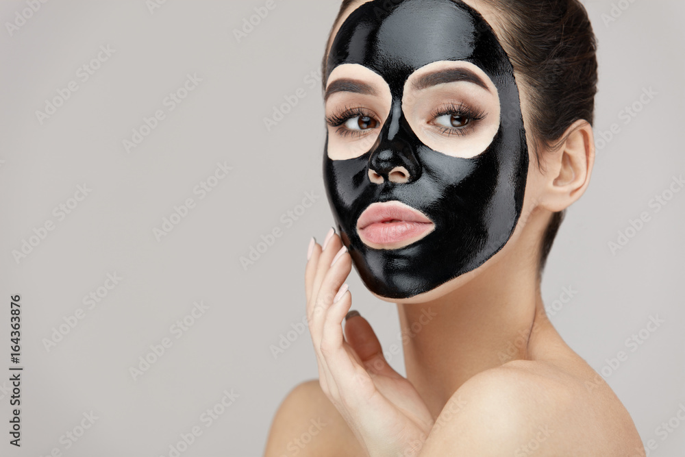 Female Beauty Face Skin Masking. Girl With Black Peeling Mask Female Beauty Face Skin Masking. Girl With Black Peeling Mask