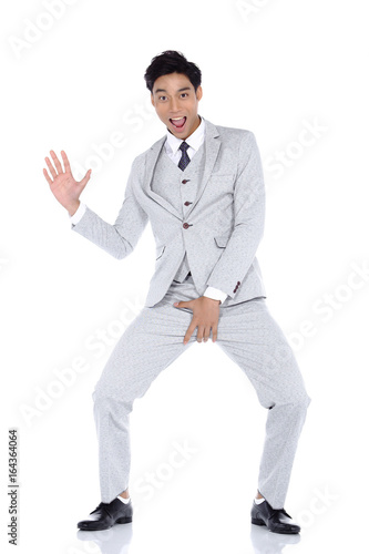 Gray Dot Suit Pant Businessman, Tan skin man acting funny pose, studio lighting white background isolated © Jade