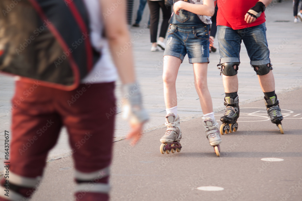 People rollerblading in a summer city