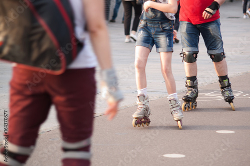 People rollerblading in a summer city