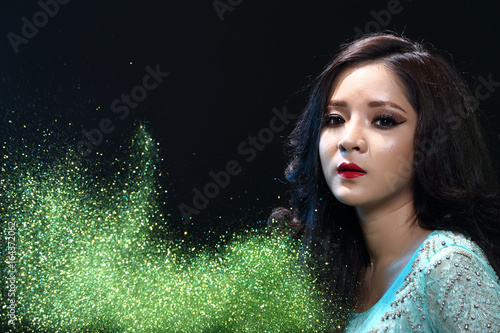 Woman with Gllitter Snowflake in dark background photo