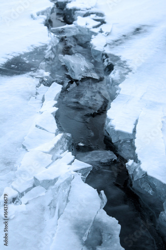 Wallpaper Mural Ice hummocks on the northern shore of Olkhon Island on Lake Baikal. Fresh crack broke the thick ice. Fresh clean water rises from the depths and freeze in the cold. Ice Storm. Photo partially tinted Torontodigital.ca