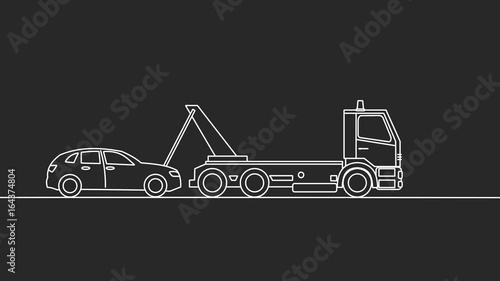 Tow truck picking up a vehicle, on black background photo