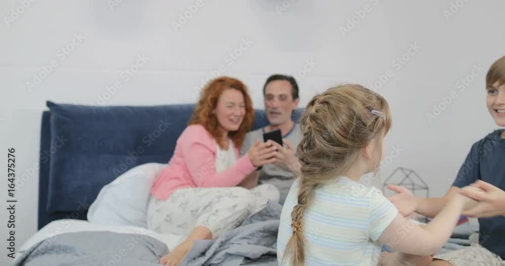 Sister And Brother Playing Together Over Parents Use Cell Smart Phone Sitting On Bed Family Together In Bedroom Slow Motion 60 Sister And Brother Playing Together Over Parents Use Cell Smart Phone Sitting On Bed Family Together In Bedroom Slow Motion 60
