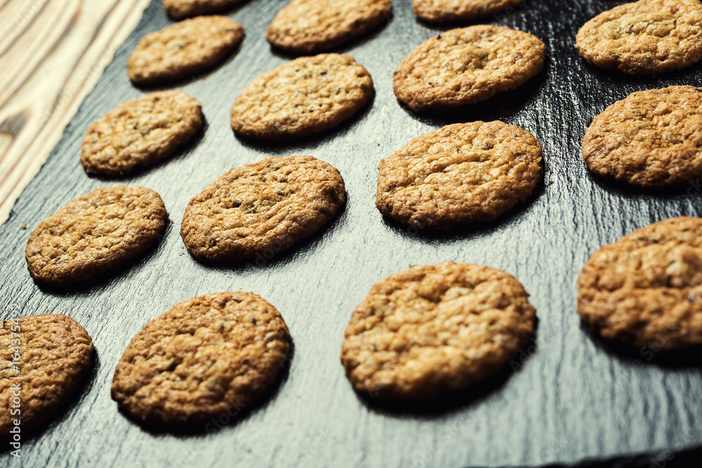 Biscuit sweet cookie background. Domestic stacked butter biscuit pattern concept,close up macro.Homemade cookies on wooden table.Cereal biscuits with the sesame,peanuts,sunflower and amaranth. Biscuit sweet cookie background. Domestic stacked butter biscuit pattern concept,close up macro.Homemade cookies on wooden table.Cereal biscuits with the sesame,peanuts,sunflower and amaranth.