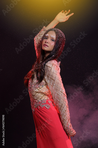 Woman with Gllitter Snowflake in dark background photo