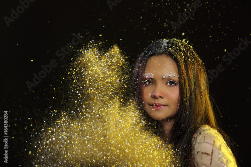 Woman with Gllitter Snowflake in dark background photo