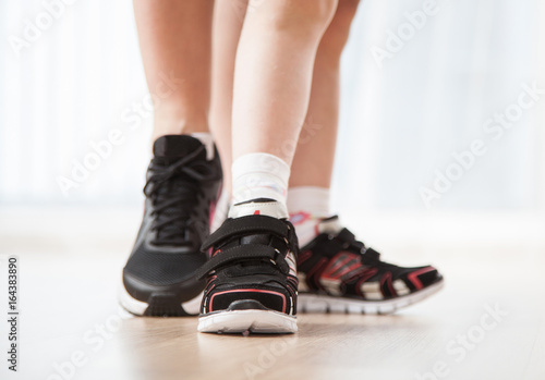 Women's and child's feet in sneakers