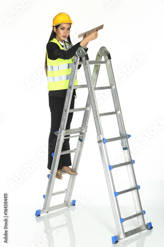 Tall Ladder stair and hit something with hammer. concept woman can fix