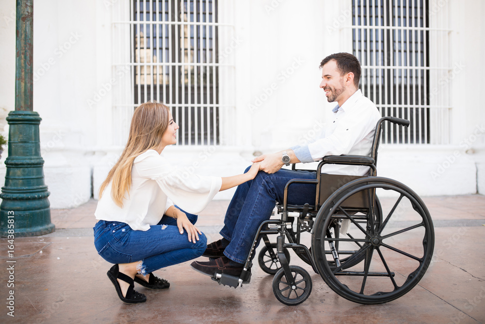 Couple in love, man on a wheelchair Couple in love, man on a wheelchair