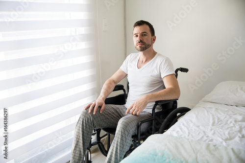 Latin man on wheelchair at home