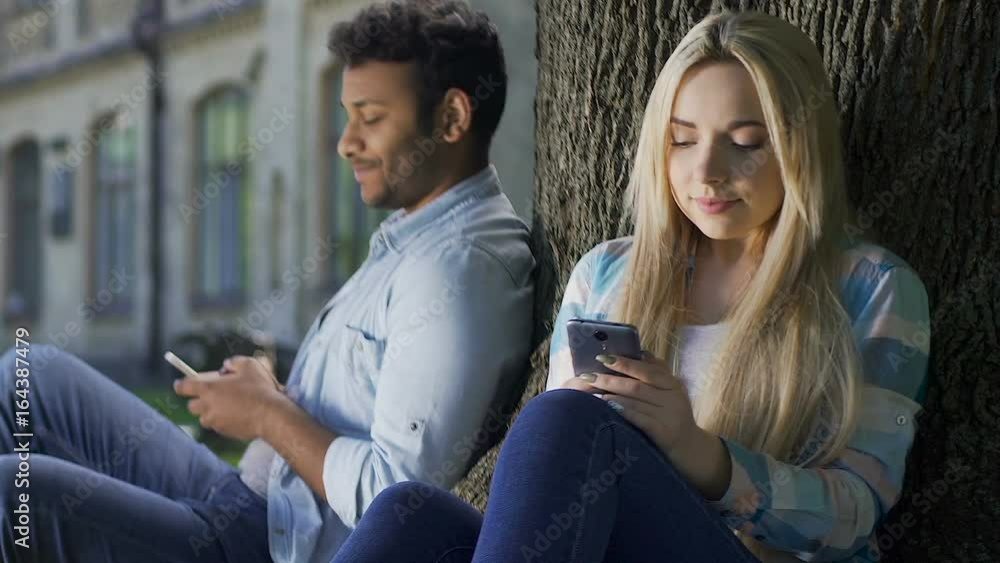 Youth looking at each other not daring to get acquainted, love at first sight Youth looking at each other not daring to get acquainted, love at first sight