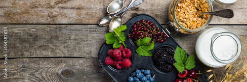 Breakfast concept - granola, milk and berries