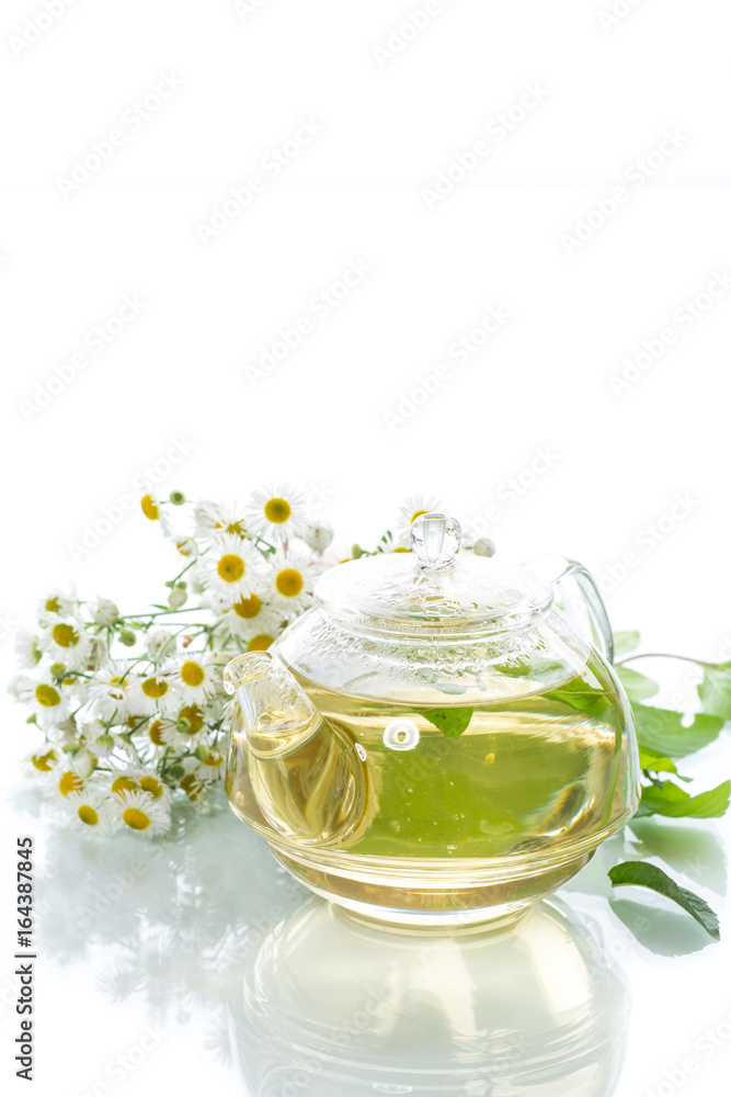 Glass teapot with chamomile tea Glass teapot with chamomile tea
