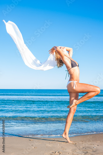 beautiful woman in bikini with pareo on the beach