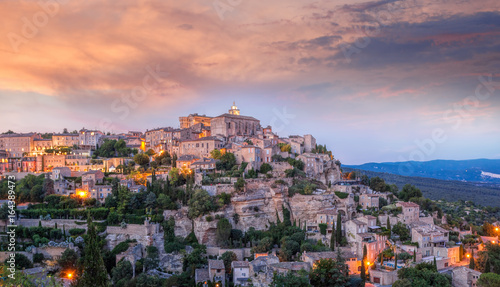 Famous old village Gordes in Provence against sunset in France photo