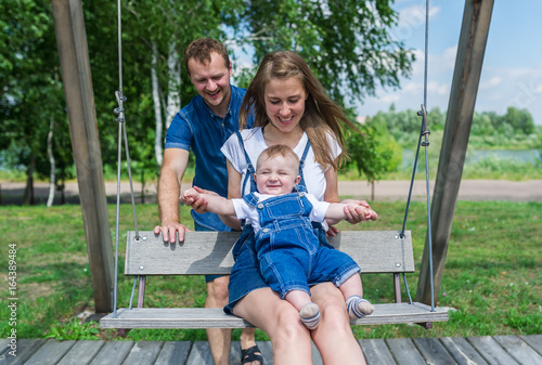 Family having fun on a swing © Irina84