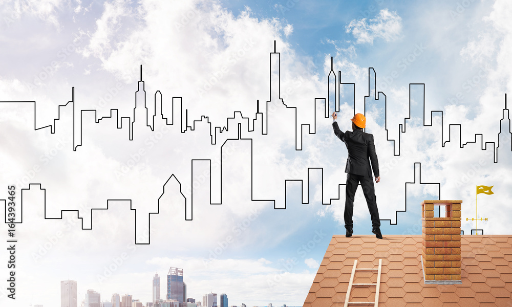 Man architect draw silhouette of modern city on blue sky. Mixed media Man architect draw silhouette of modern city on blue sky. Mixed media