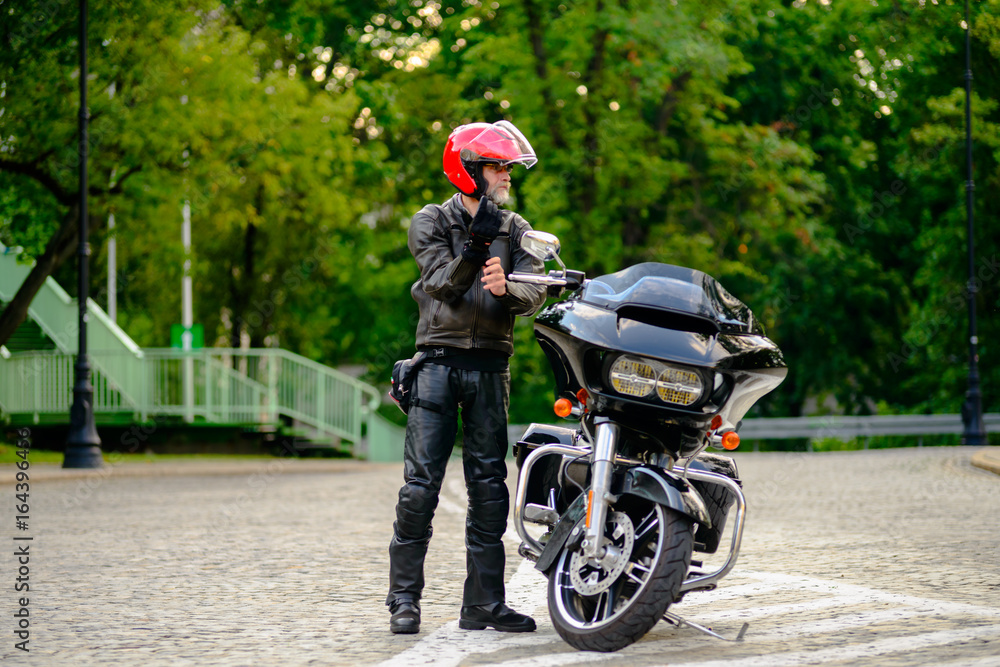 Rider and his black custom motorbike Rider and his black custom motorbike