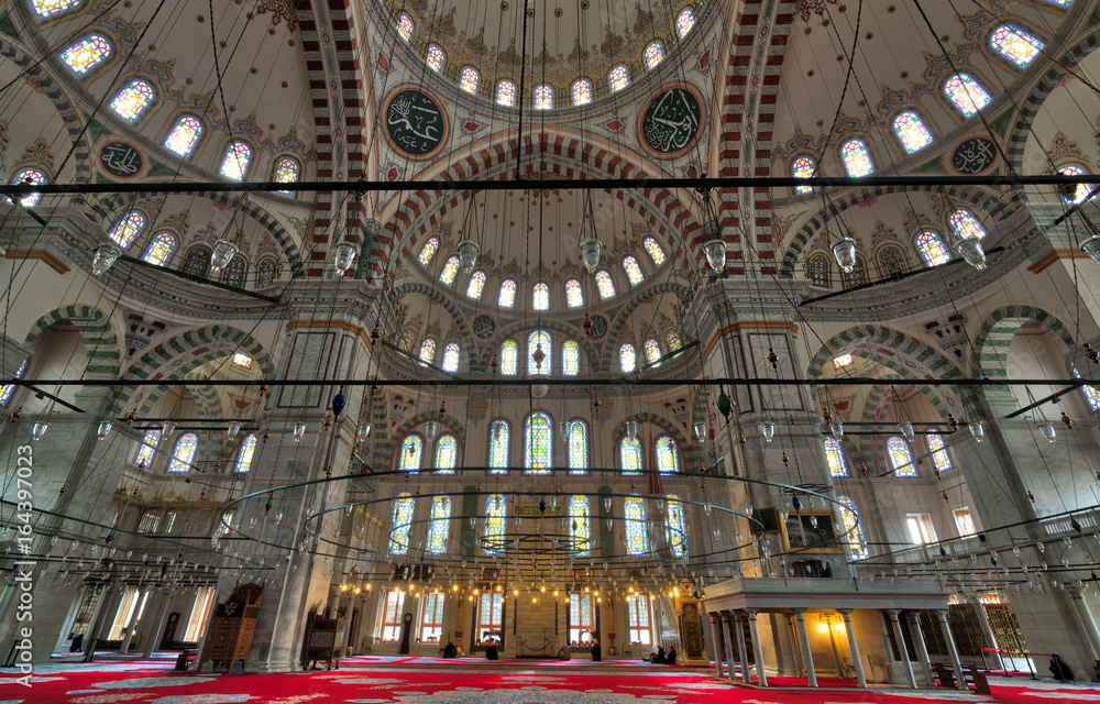 Fatih Mosque, a public Ottoman mosque in the Fatih district of Istanbul, Turkey, with a huge decorated domes & many colored stained glass windows