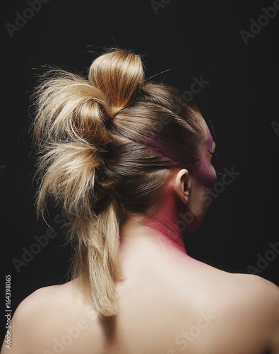 Portrait of young fashion woman with beautiful hairstyle over black background