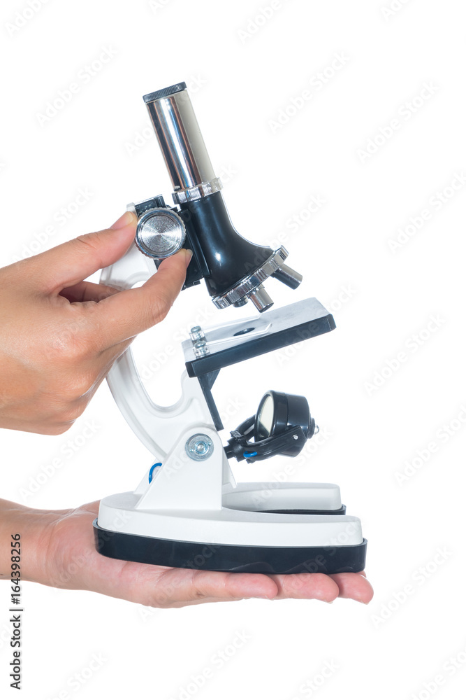Female hand holding white science microscope isolated on white background Female hand holding white science microscope isolated on white background