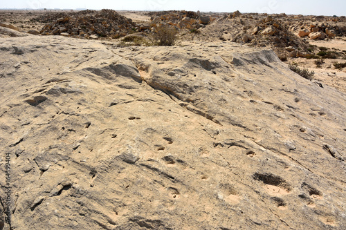 Rock outcrop with ancient dot carvings in Jebel Jassassiyeh in Northern Qatar.