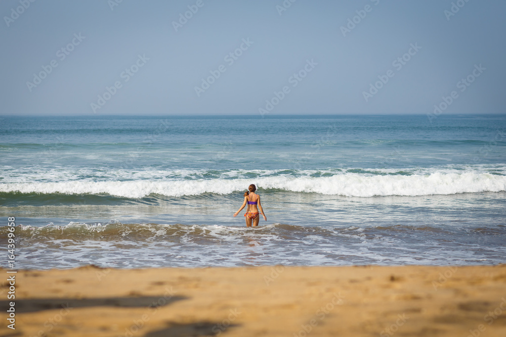 Woman and the sea. Girl playing with waves. The waves are raging. Happiness. Meeting with the sea. Vacation. Resort. Sunny day by the sea. Ocean. A woman is enjoying herself. Sand beach. Woman and the sea. Girl playing with waves. The waves are raging. Happiness. Meeting with the sea. Vacation. Resort. Sunny day by the sea. Ocean. A woman is enjoying herself. Sand beach.