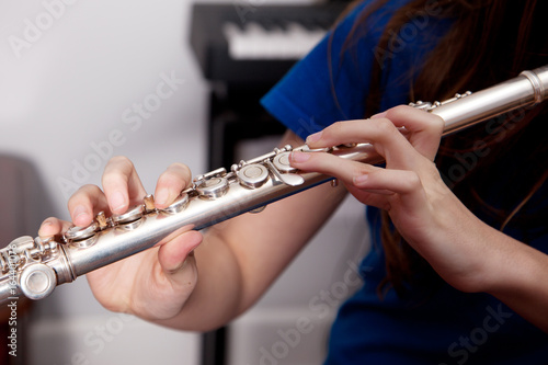 Close up of a flautist playing a flute.