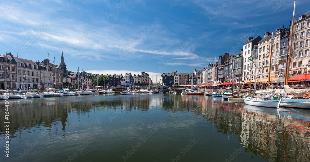 Editorial Honfleur, France - July 05, 2017: Honfleur harbour in France's Normandy region, sited on the estuary where the Seine river meets the English Channel