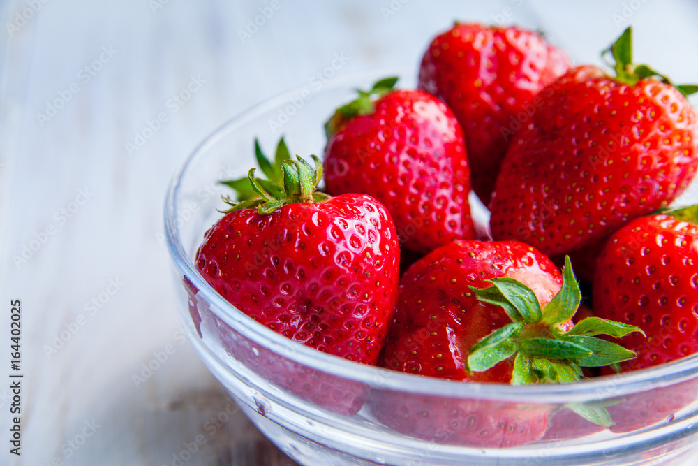 Strawberries on the plate on white wooden background for breakfast Strawberries on the plate on white wooden background for breakfast