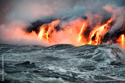 Schilderij op canvas Molten lava flowing into the Pacific Ocean on Big Island of Hawaii at sunrise