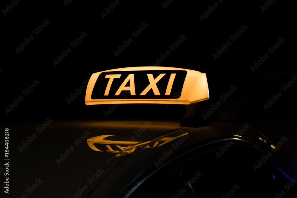 Naklejka premium taxi sign illuminated, taxi sign at night