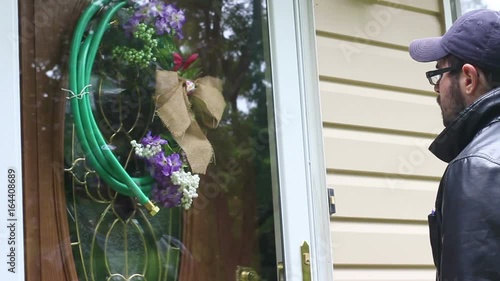 A woman is served at her house by a process server in disguise
