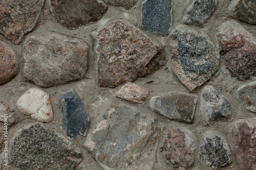 Fragment of old stone wall closeup.