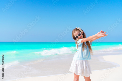 Portrait of adorable little girl outdoors on the beautiful tropial beach