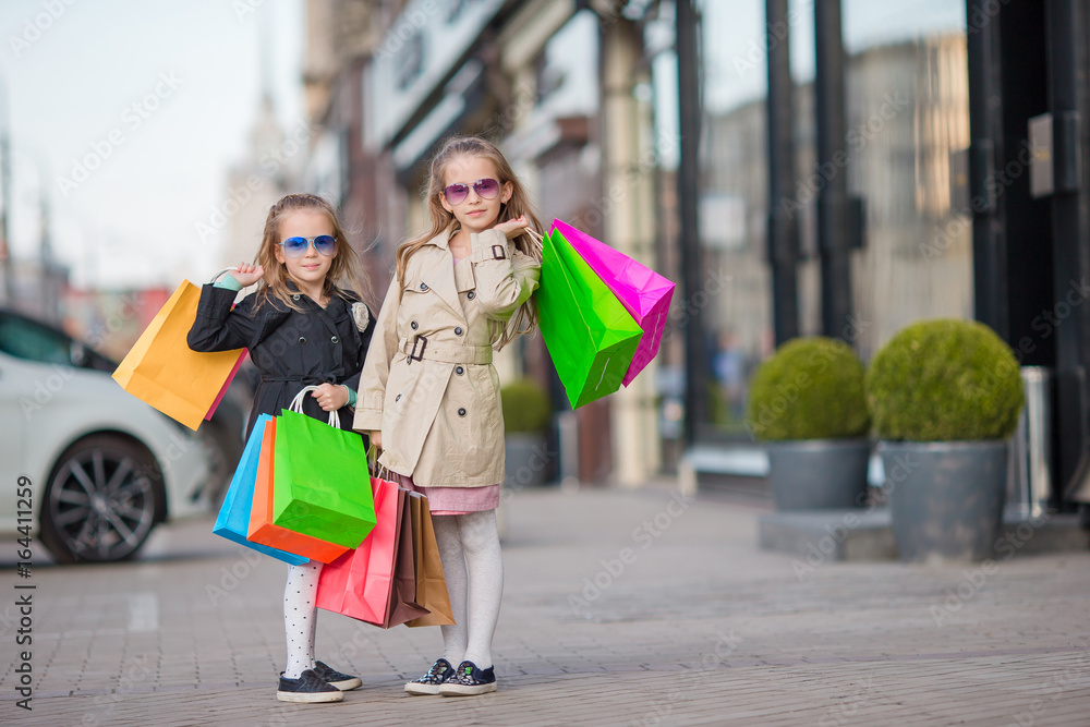 Adorable little girls on shopping in the city outdoors Adorable little girls on shopping in the city outdoors