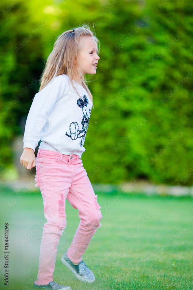 Little adorable girl outdoors in the park Little adorable girl outdoors in the park