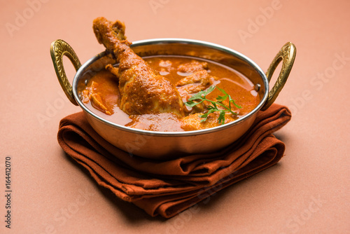 Indian spicy Chicken curry or masala chicken with prominent leg piece, popular recipe from India, selective focus
