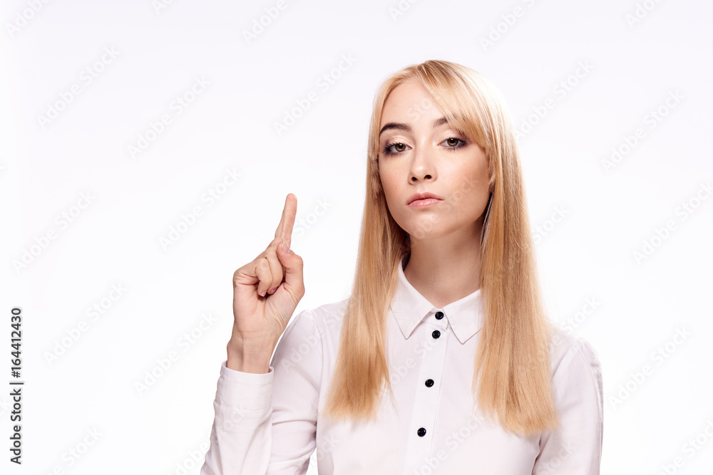 Beautiful young woman on white isolated background shows on empty space Beautiful young woman on white isolated background shows on empty space