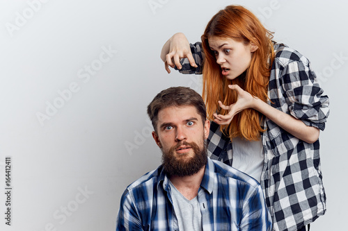 Young beautiful woman and guy with beard on white isolated background, repair, building materials, tools
