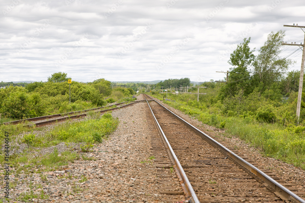 Single train track with siding in rural setting Single train track with siding in rural setting