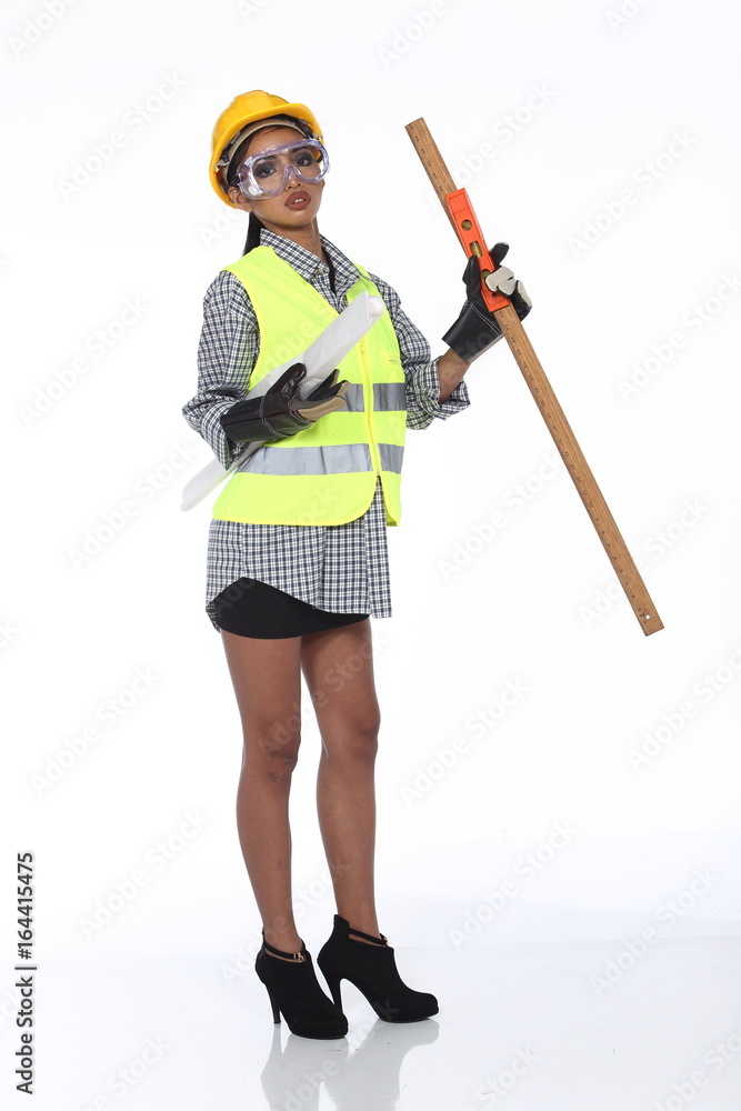 Asian Architect Engineer woman in yellow hard hat, safety vast equipment, thick gloves, protector glasses goggle and equipment Asian Architect Engineer woman in yellow hard hat, safety vast equipment, thick gloves, protector glasses goggle and equipment