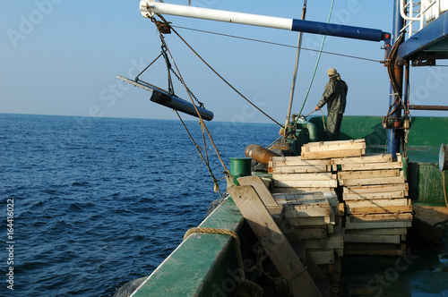 Fishing boat and working fisherman